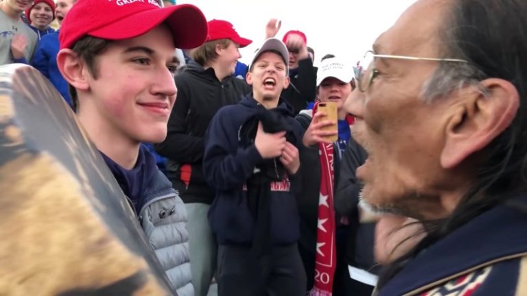 A student from Covington Catholic High School and Nathan Phillips