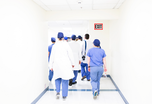 Health care nurses doctors walking away Original Photo by Luis Melendez on Unsplash