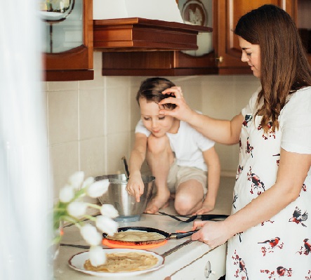 Mother in apron in kitchen with child pexels-elina-fairytale-3807358