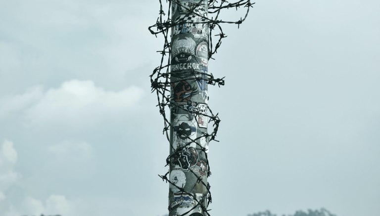 Pole barb wire original Photo by Duangphorn Wiriya on Unsplash