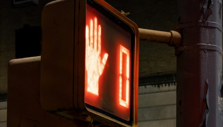 Crosswalk sign stop zero original Photo by the blowup on Unsplash