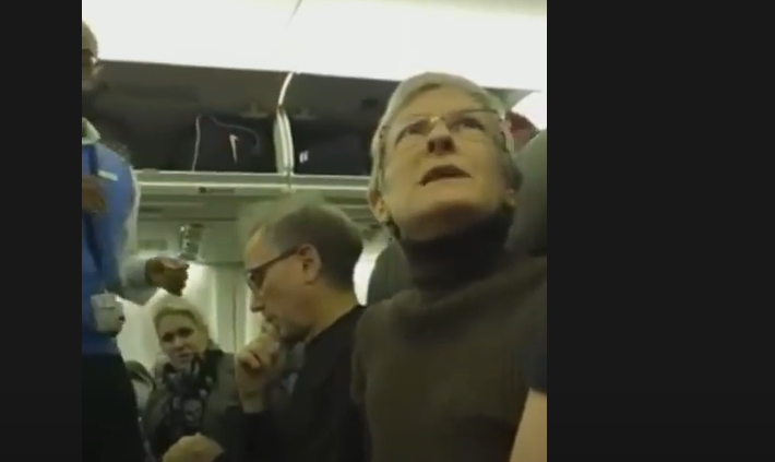 woman on plane screen grab YouTube