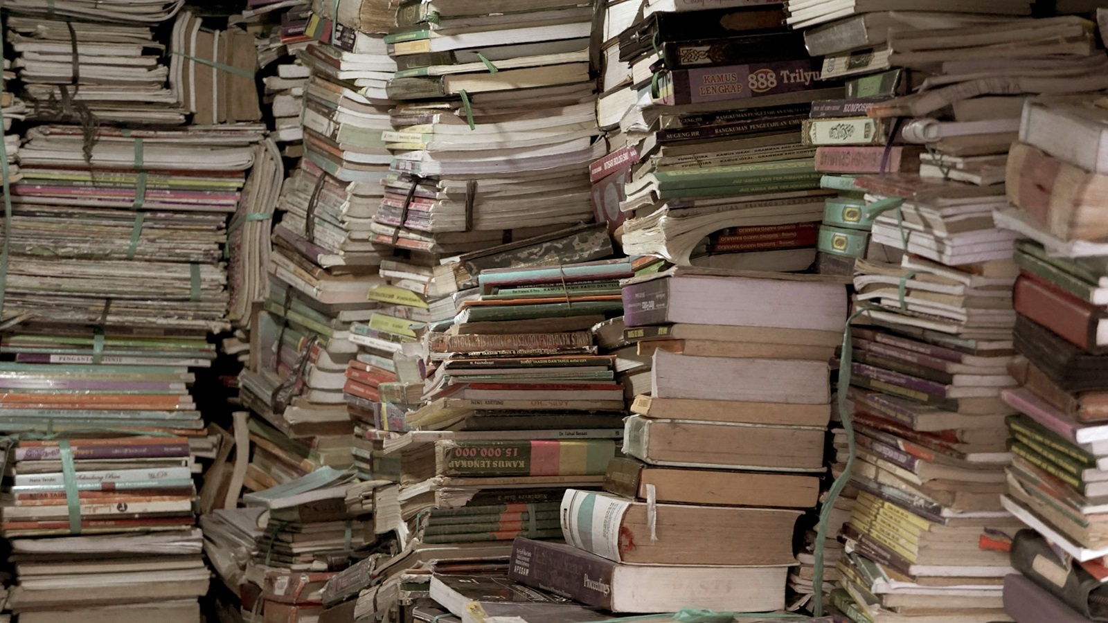 piles of books and babers Photo by Carles Rabada on Unsplash