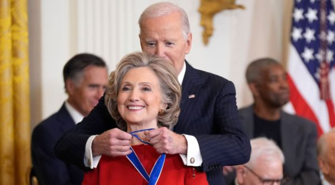 Biden gives medal of honor to hillary clinton